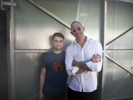 a young man wearing a monkey tshirt and an older monkey wearing a plain white shirt