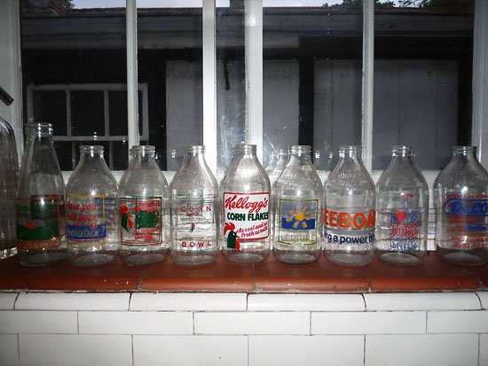 there was ten milk bottles hanging on the wall...
